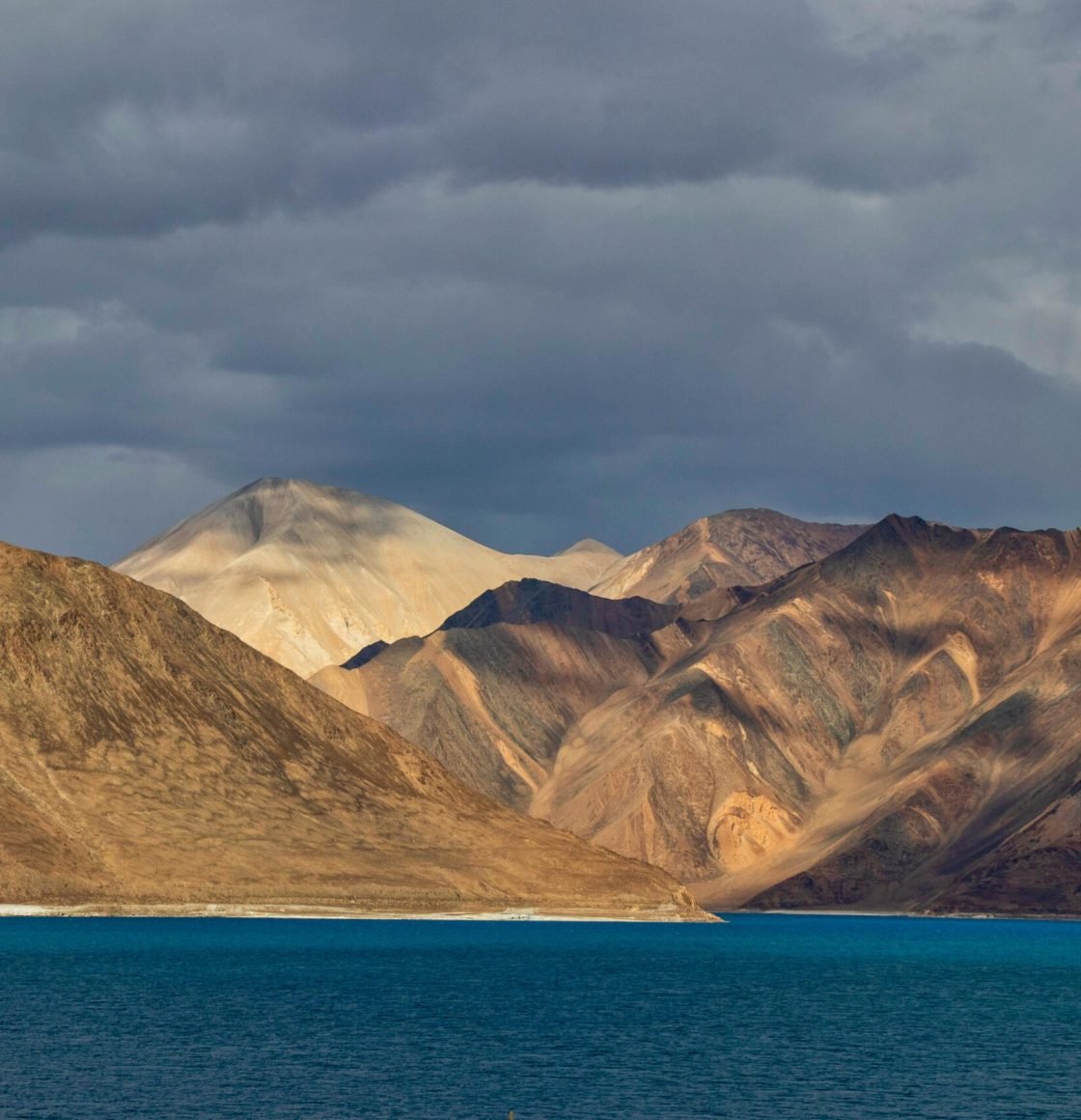 pexels photo 2702627 2702627 Stunning landscape of Pangong Lake with the majestic Himalayan mountains under a dramatic sky.