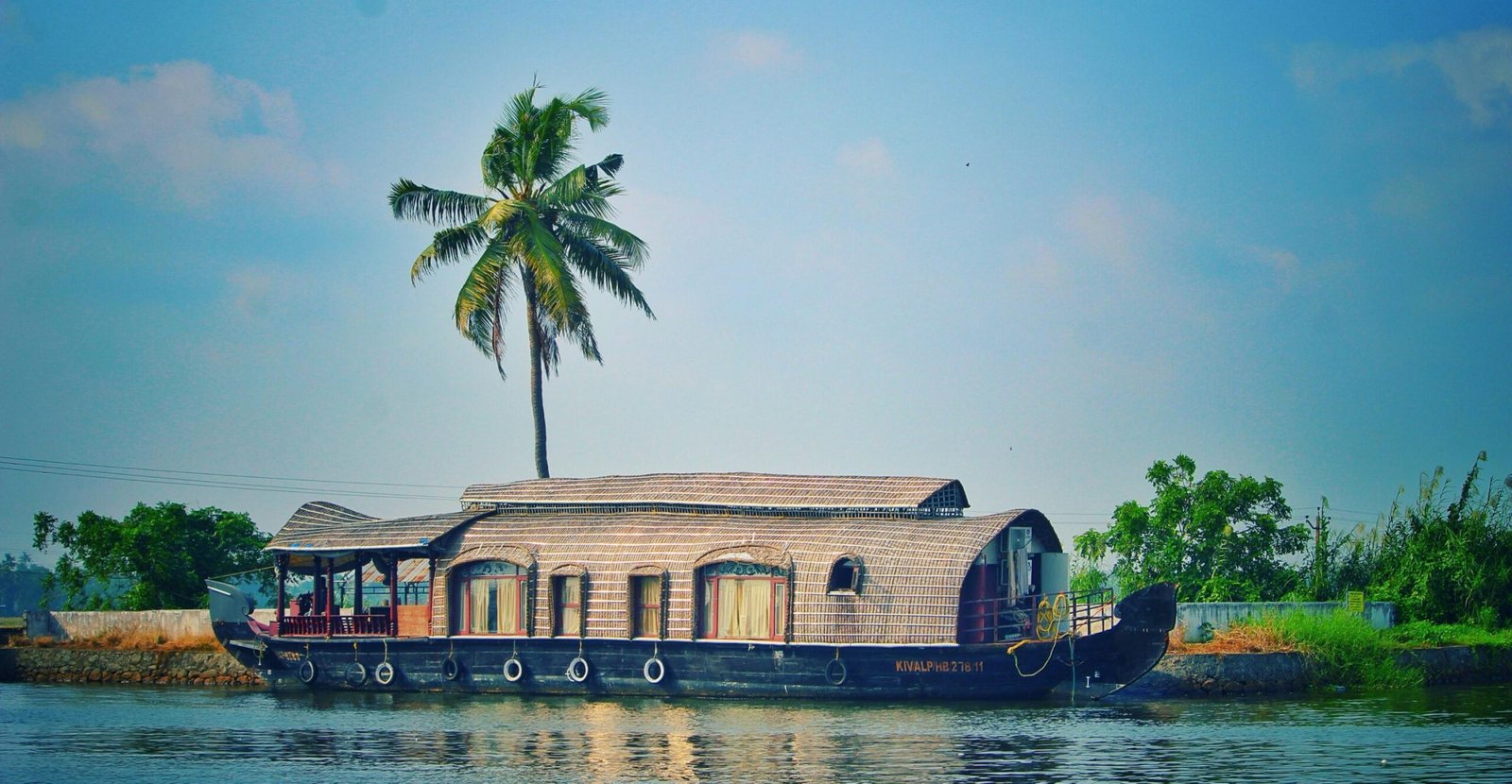 pexels photo 962464 962464 Picturesque view of river with green palms on bank and shabby wooden boathouse under blue sky in tropical countryside